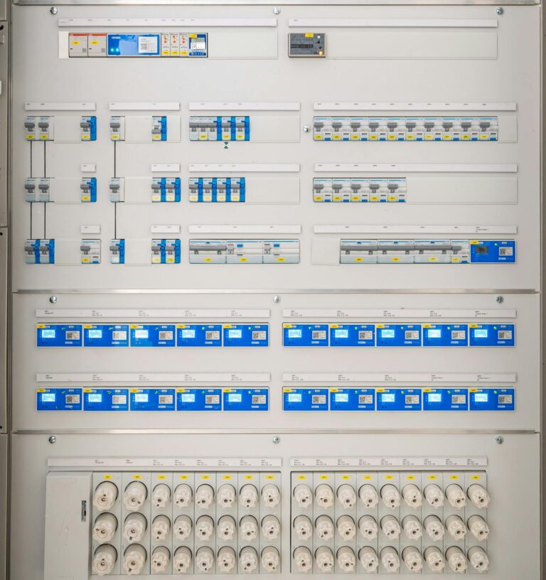 Detailed view of a modern electrical panel featuring circuit breakers and sockets for efficient energy distribution.